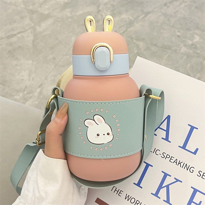 Wholesale of high-appeartion-level insulated cups for the Year of the Rabbit, children's stainless steel portable creative drinking cups for boys and girls, portable shoulder straps