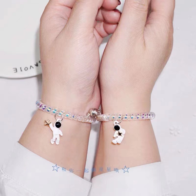 A pair of astronaut magnets attracting each other couple bracelets for boyfriend. Korean version headband, telephone line and hair band for female students
