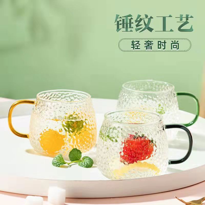 We are selling glass hammer-patterned cups, colored handle cups, household drinking cups, glass cups, juice coffee cups and handle cups in stock details Picture
