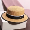 A white flat-topped straw hat with an M logo, a female summer outing sunshade beach hat, a model's catwalk performance, and a fashionable top hat Application Scenario