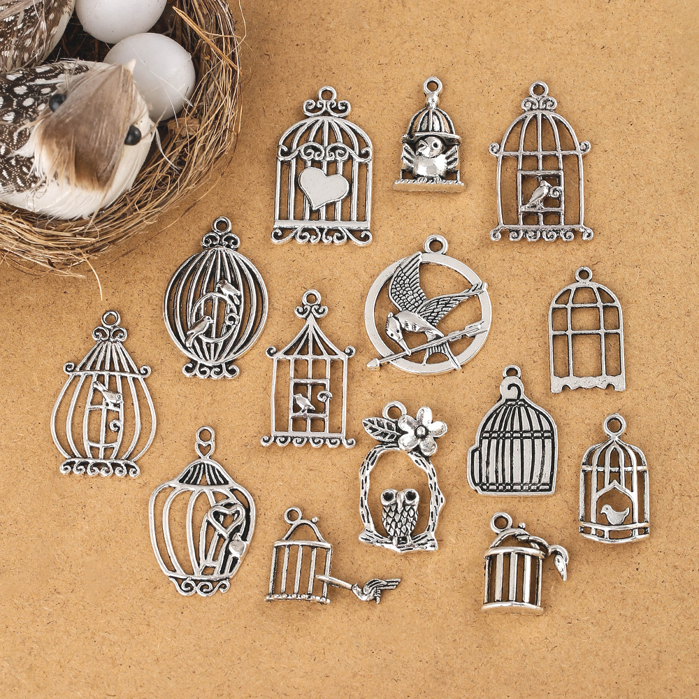 Yiwu alloy DIY jewelry accessories, birdcages, window hollowed-out landscape pendants, and embossed pendants are selling well details Picture