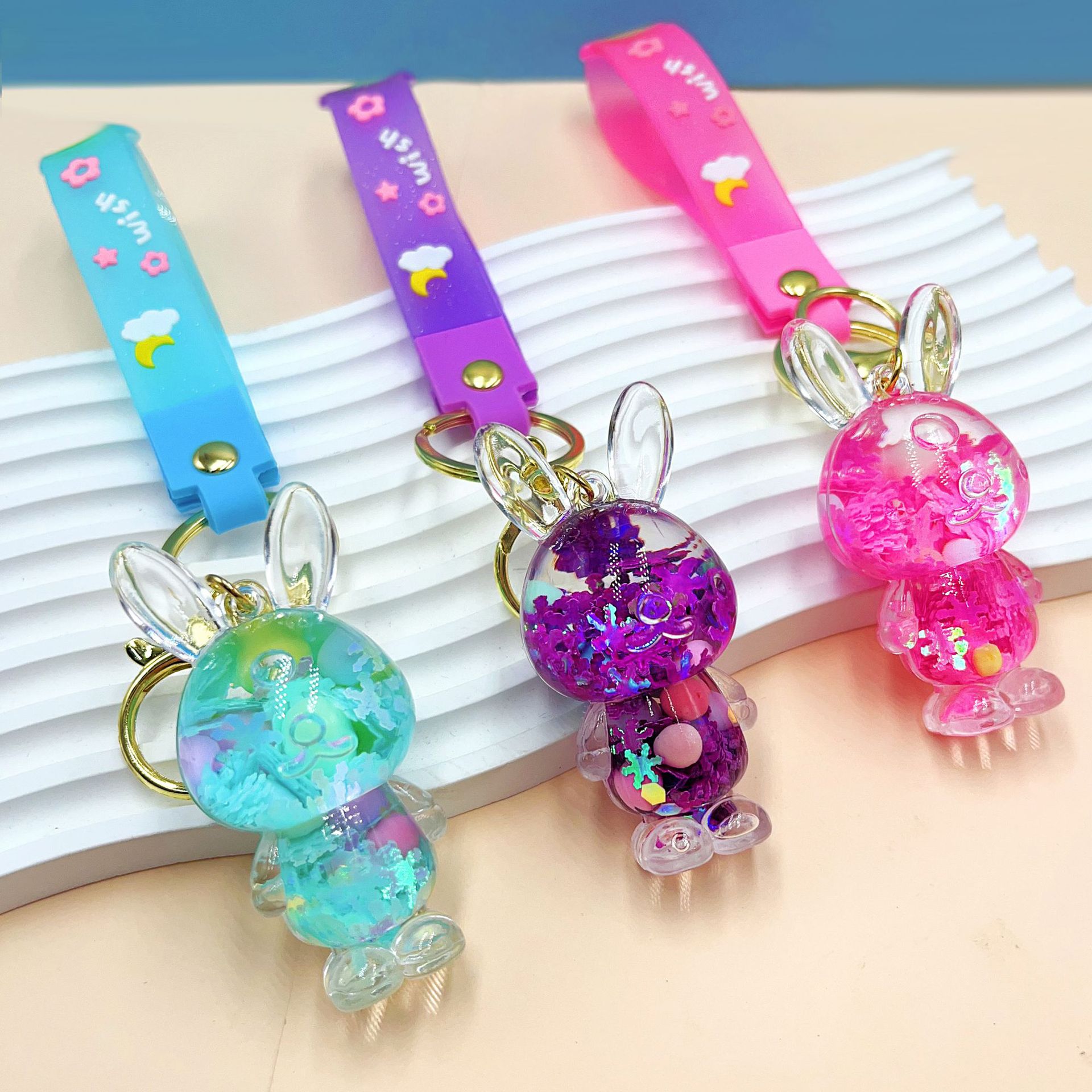 Wholesale of creative oil sugar bean lucky rabbit key chains, liquid flowing sand, acrylic key chains, car pendants and ornaments details Picture