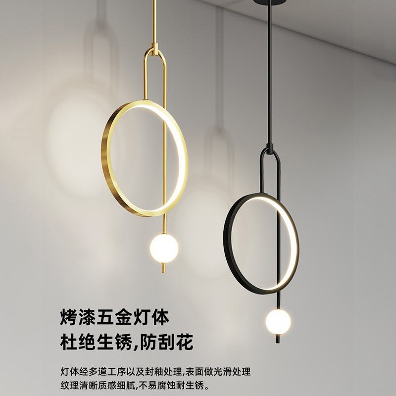 The bedside chandelier in the bedroom is a modern and simple Nordic light luxury living room background wall. It is a creative bedside lamp designed by a popular designer details Picture