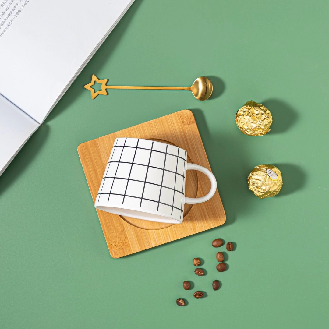 Couple black and white coffee cups, star spoons, ceramic cups with bamboo pads, mugs, Nordic line water cups, European style details Picture