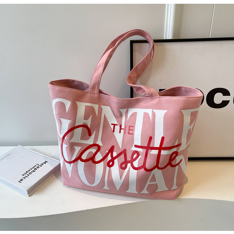 A new 2024 Korean-style large-capacity tote bag for girls, a niche canvas bag with fashionable letters and a fresh and clean shoulder bag
