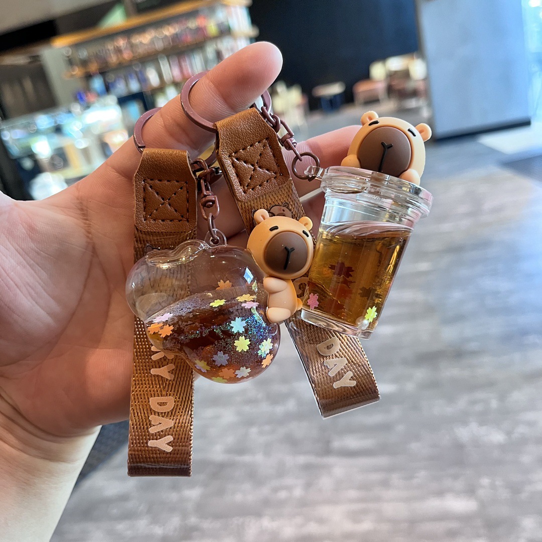 Nuevo diseño de dibujos animados arena movediza en aceite llavero colgante bolsa de escuela taza de té de leche lindo muñeca máquina pequeño regalo delicado details Picture