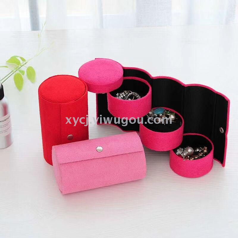 A cylindrical three-layer jewelry storage box