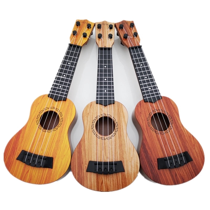 The children's small guitar is a toy that can play a medium-sized ukulele, a beginner's instrument, and comes with a pick for music Item Picture
