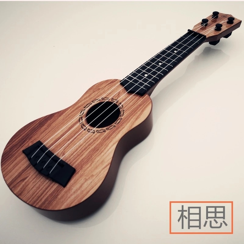 The children's small guitar is a toy that can play a medium-sized ukulele, a beginner's instrument, and comes with a pick for music Specification drawing
