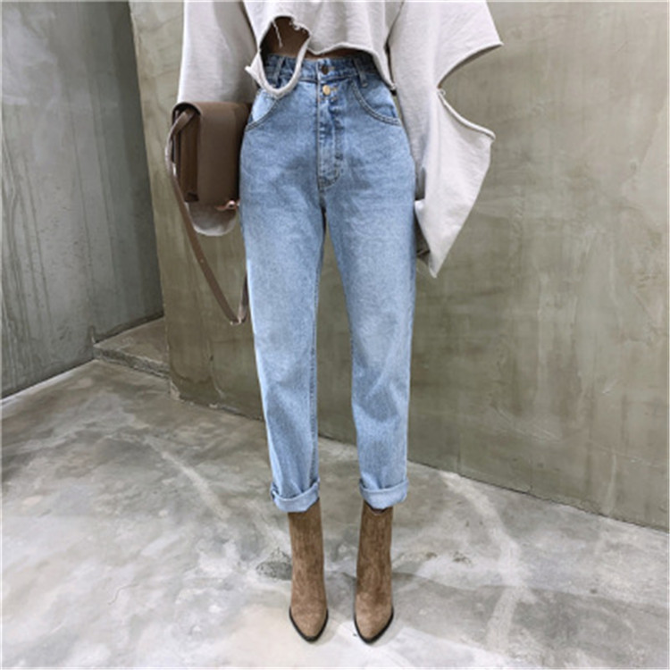 A pair of loose, high-waisted washed blue 2-button skinny jeans featuring a female Instagram influencer from Dongdaemun, South Korea, for Spring/Summer 2020