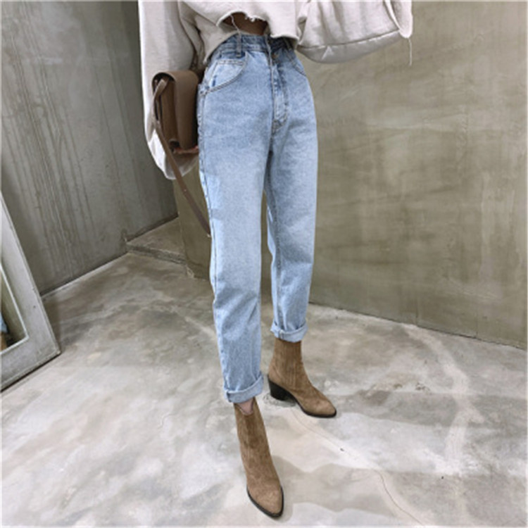 A pair of loose, high-waisted washed blue 2-button skinny jeans featuring a female Instagram influencer from Dongdaemun, South Korea, for Spring/Summer 2020 details Picture