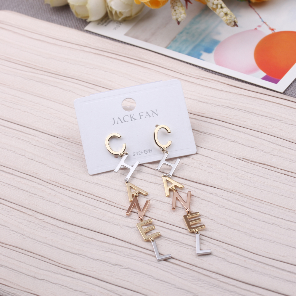 A set of three-piece personalized earrings featuring circular metal discs, thin vertical strips, irregular and asymmetrical stud earrings