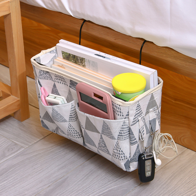 Multi-functional bedside hanging bag for home use, fabric hanging basket beside the bed in college dormitories, and a bag for organizing and storing miscellaneous items on the bed Application Scenario