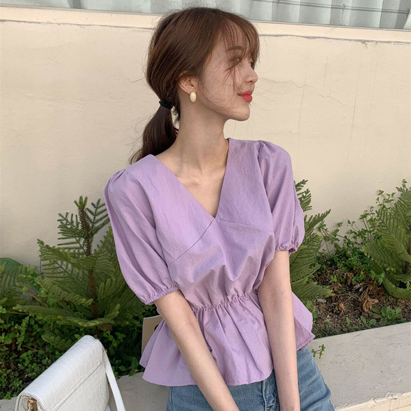 A chic and energetic Korean girl's V-neck, cinched waist short shirt that makes her look younger