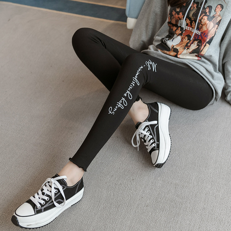 Real photo of a woman wearing leggings outside a yoga pose for the Spring Festival of 2021 to achieve a slimming figure with a tight waist, elastic waist, and seamless legs details Picture