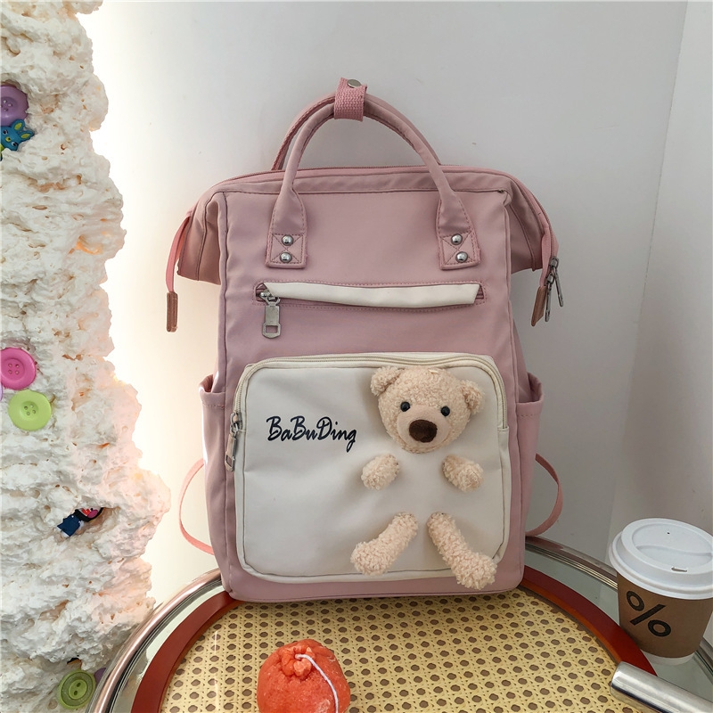 The production of a cute and playful schoolgirl backpack with a cute doll bear and a large capacity of casual student backpacks details Picture