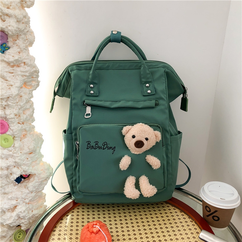 The production of a cute and playful schoolgirl backpack with a cute doll bear and a large capacity of casual student backpacks Application Scenario