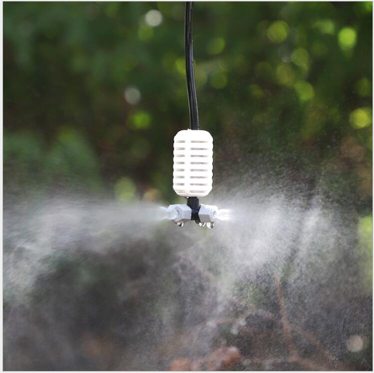 The grey cross-shaped atomizing micro-sprinkler heads are used for cooling and humidifying the roof of the four-outlet greenhouse seedling raising farm details Picture
