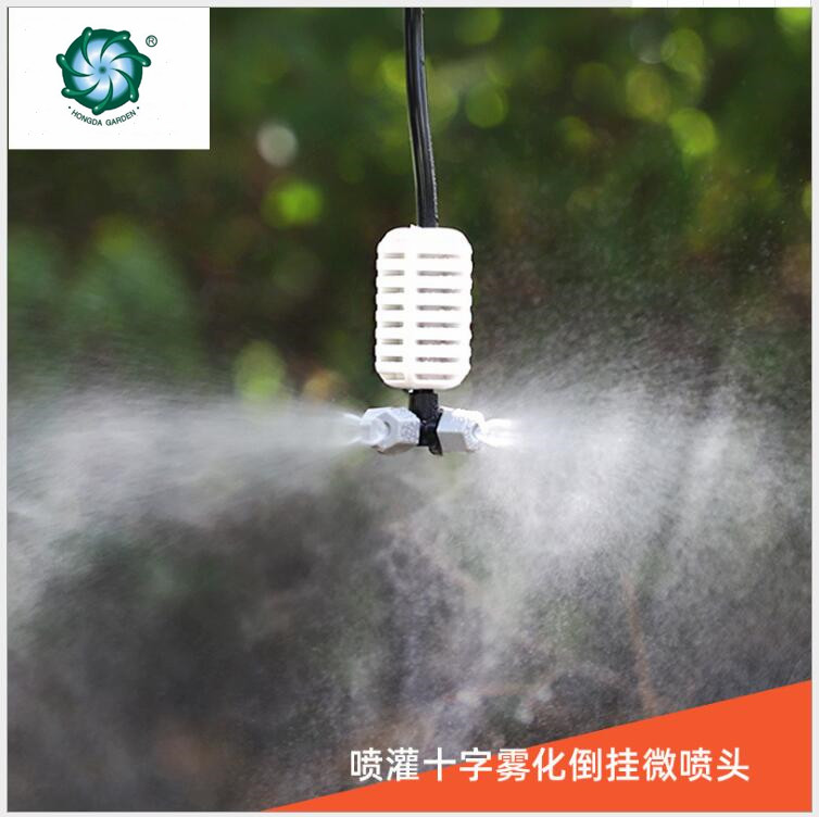The grey cross-shaped atomizing micro-sprinkler heads are used for cooling and humidifying the roof of the four-outlet greenhouse seedling raising farm full figure