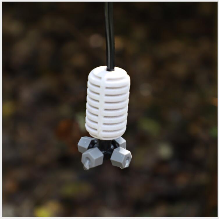 The grey cross-shaped atomizing micro-sprinkler heads are used for cooling and humidifying the roof of the four-outlet greenhouse seedling raising farm Application Scenario