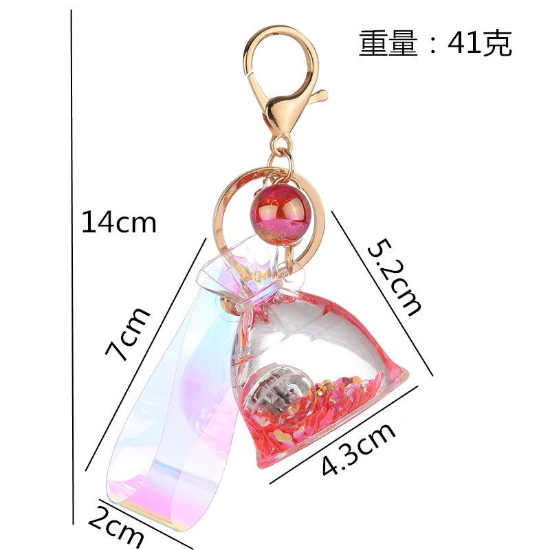 Creative acrylic cartoon flowing sand with light, lucky bag keychain, glowing oil, money bag pendant, claw machine hanging decoration Application Scenario