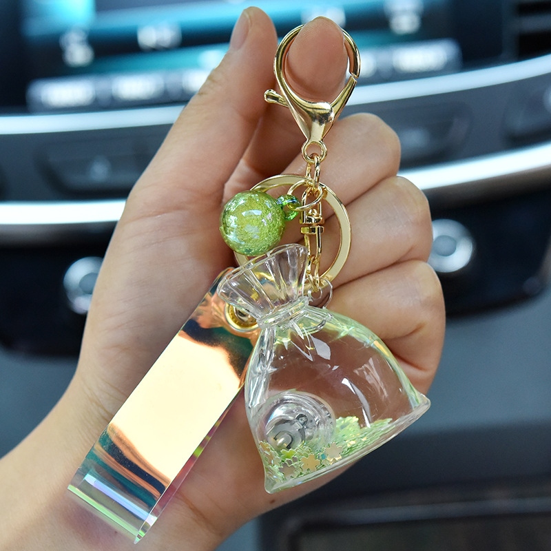 Creative acrylic cartoon flowing sand with light, lucky bag keychain, glowing oil, money bag pendant, claw machine hanging decoration Item Picture