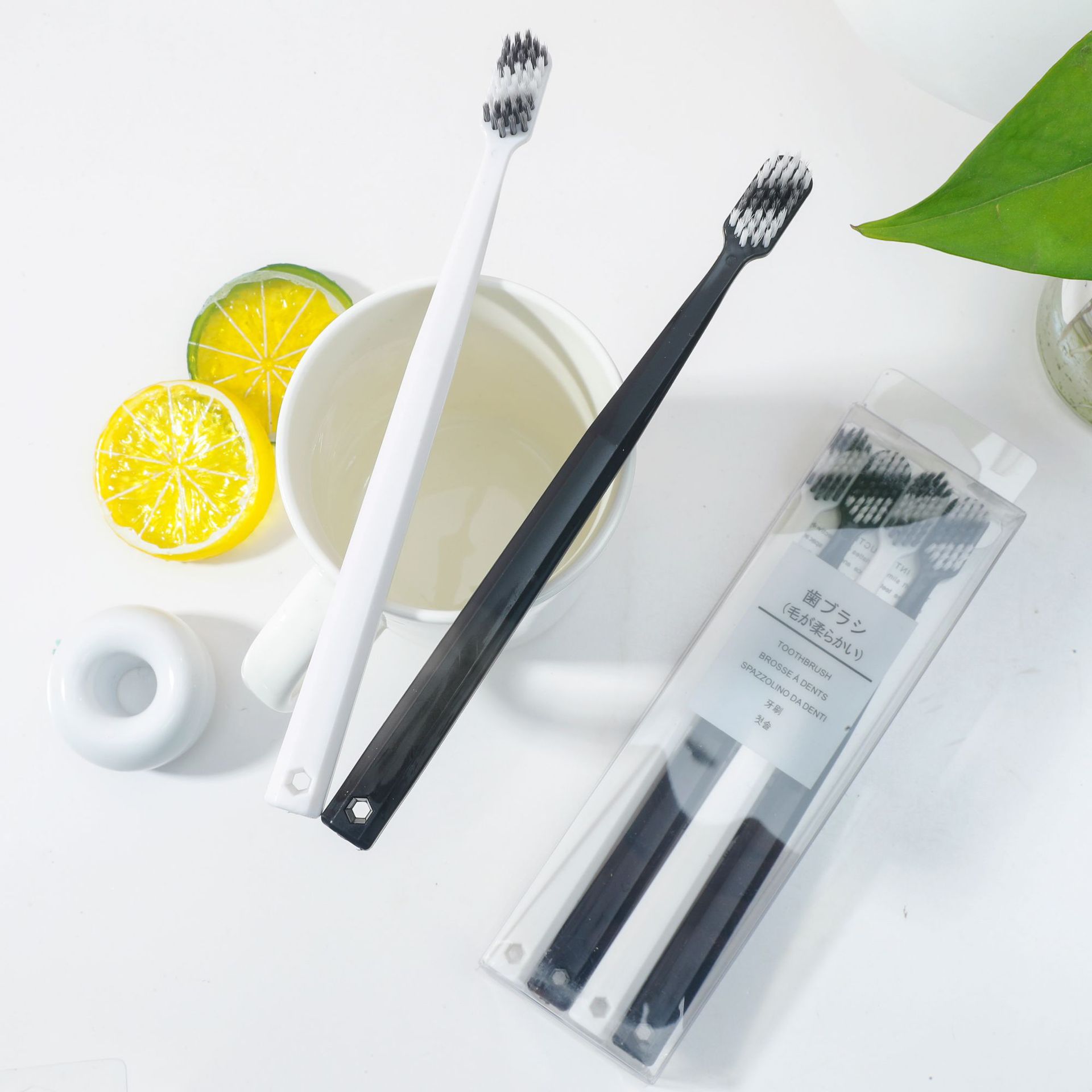 Couple toothbrushes, black and white, 4 pieces, adult fine soft bristles, 2 yuan, store street stall supply, Yiwu small commodity manufacturer Application Scenario