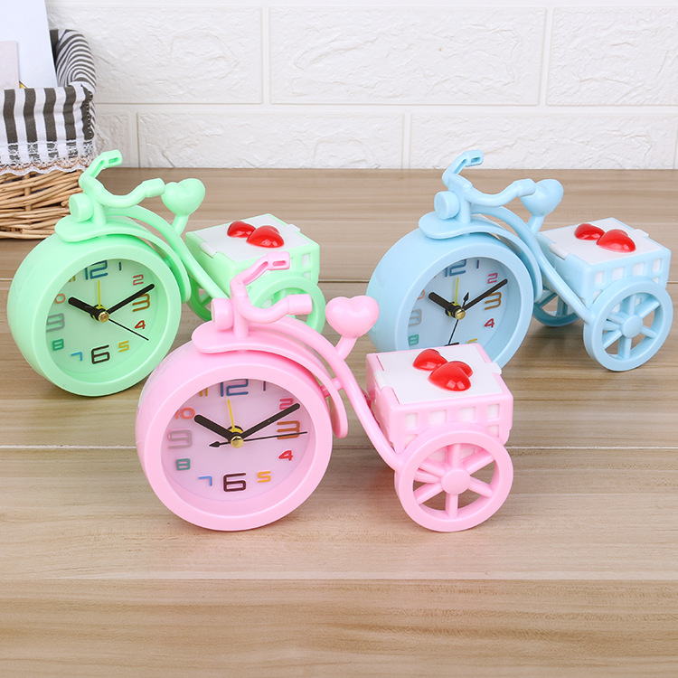 A new candy-colored tricycle alarm clock with a trunk for candies, a creative student dormitory desk and bedside alarm clock full figure