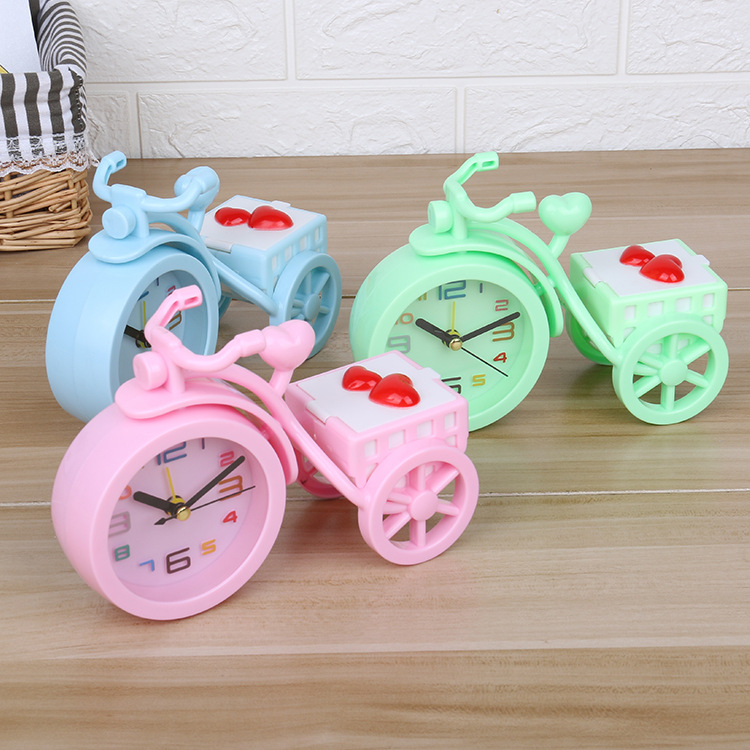 A new candy-colored tricycle alarm clock with a trunk for candies, a creative student dormitory desk and bedside alarm clock details Picture