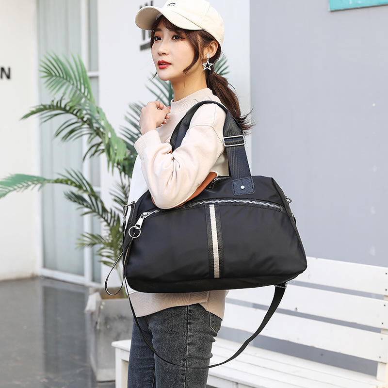 Manufacturers direct travel bag female portable short-distance leisure luggage male large capacity network red travel bag lightweight duffel bag