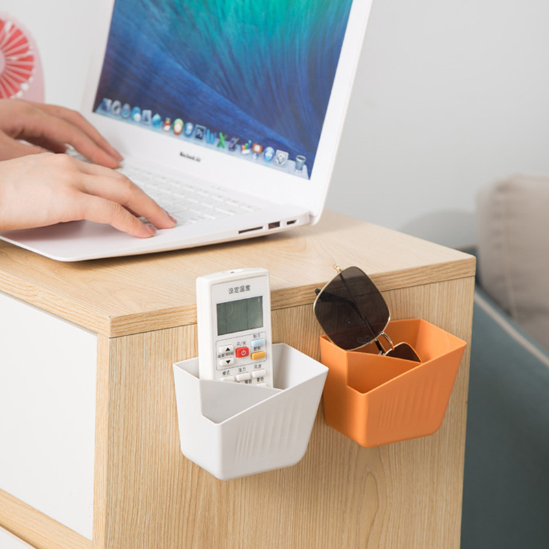 Storage box, non-perforated desktop, creative wall-mounted plastic air conditioner remote control, bedside mobile phone storage rack Application Scenario