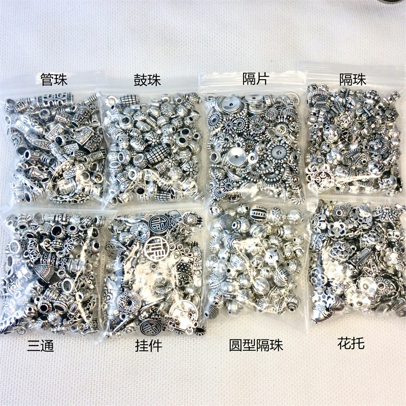 A 50g mixed bag of Tibetan silver bracelets, pendants, alloy jewelry accessories, diy flower trays, spacers, and drum beads pic 1