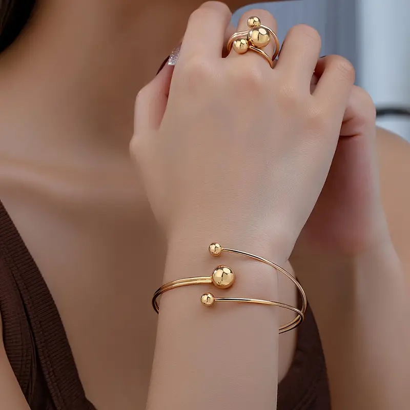 A simple, fashionable and personalized wrist and finger accessory set of gold and silver small balls with large balls in layers pic 3
