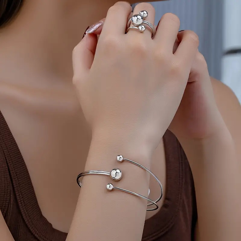 A simple, fashionable and personalized wrist and finger accessory set of gold and silver small balls with large balls in layers pic 4