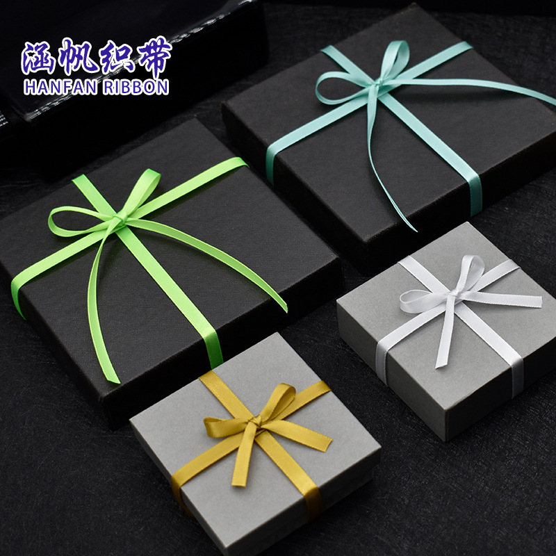 Black and grey gift box with green, blue, white and yellow ribbon bow, high-end packaging souvenir gift box, gift box