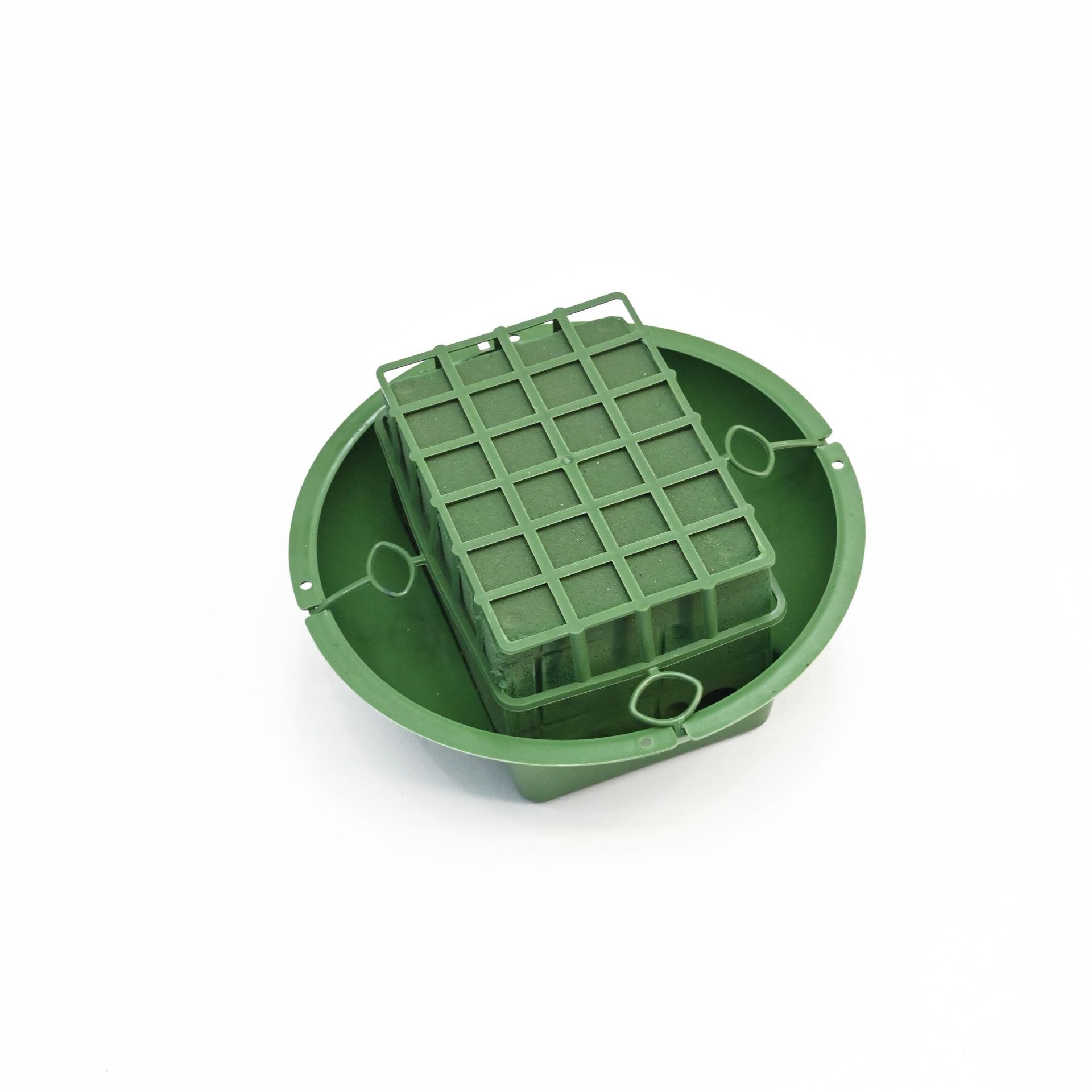 A popular green plastic flowerpot with a small round disc of mud and a grid of mud for flower arrangement