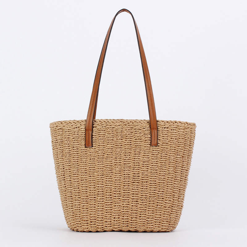 Brown leather hand-held bag with straw weaving, a small crossbody bag with artistic weaving and crocheted silver thread spliced together full image