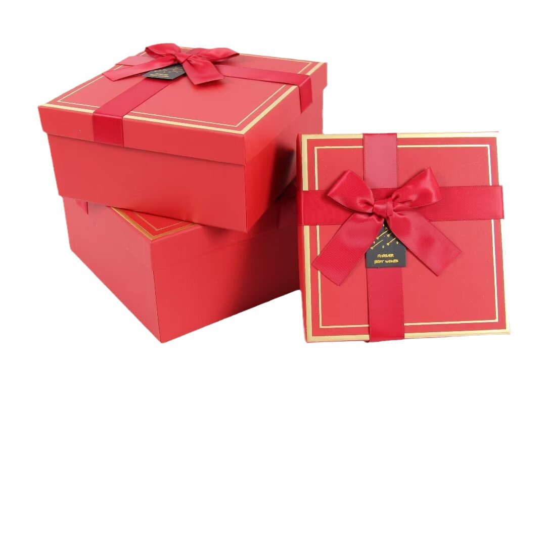 White square gift box, light blue ribbon, golden border, souvenir gift box packaging box Application Scenario