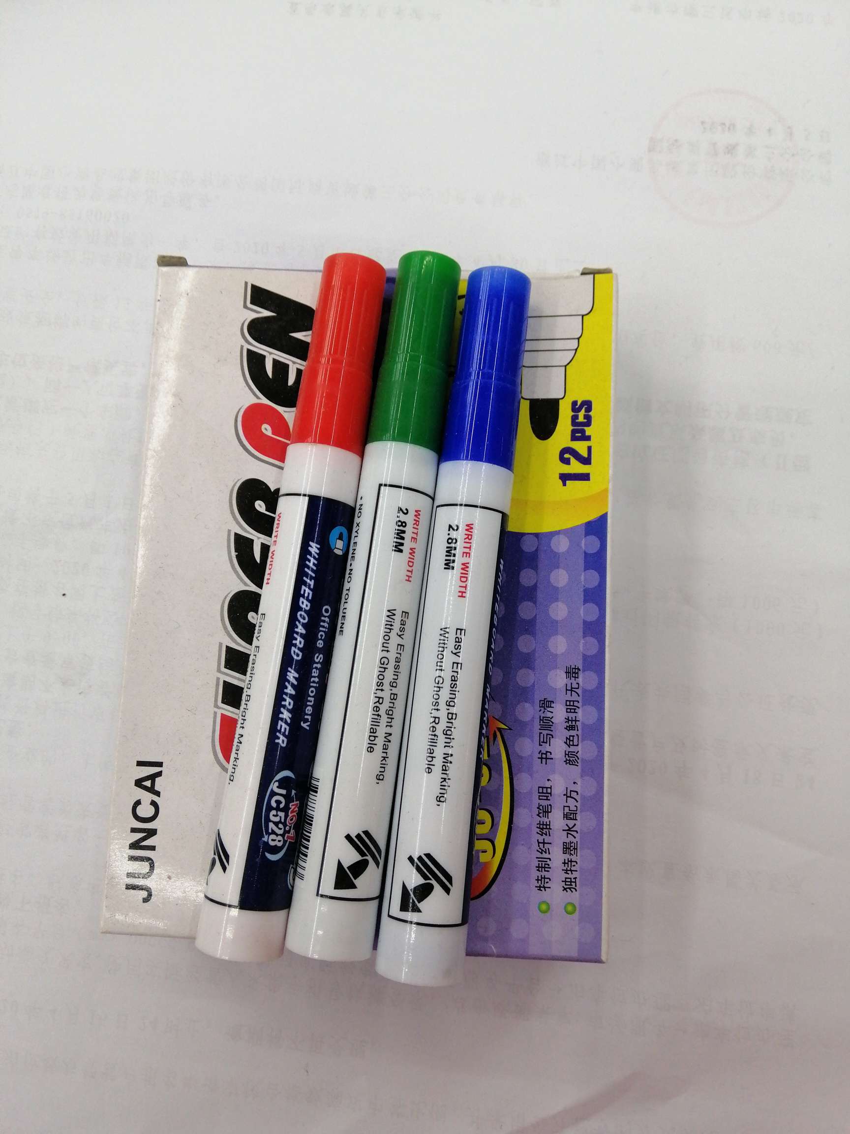 Twelve small boxes contain whiteboard pens full figure