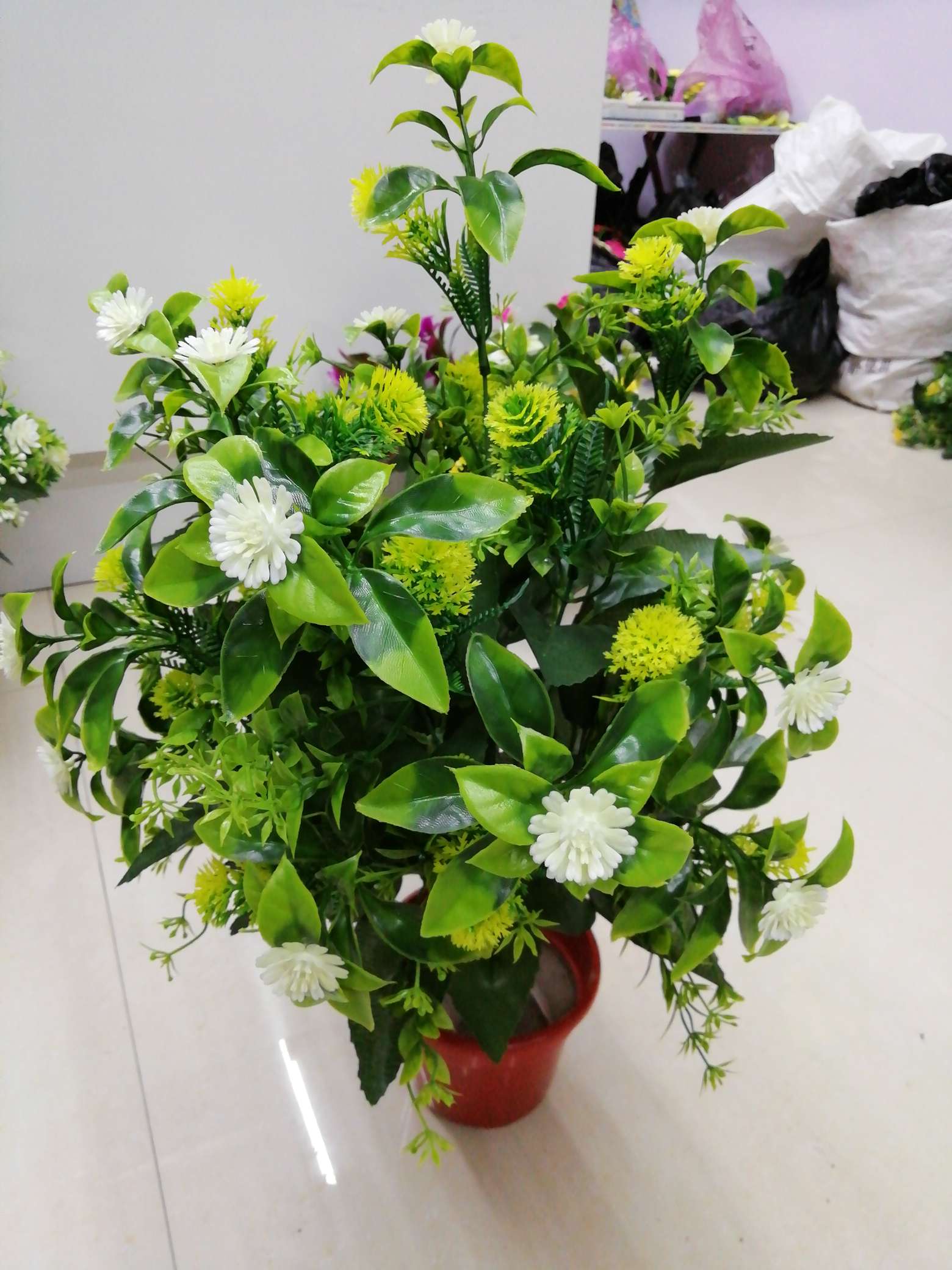 Eighteen plastic flowers and plants