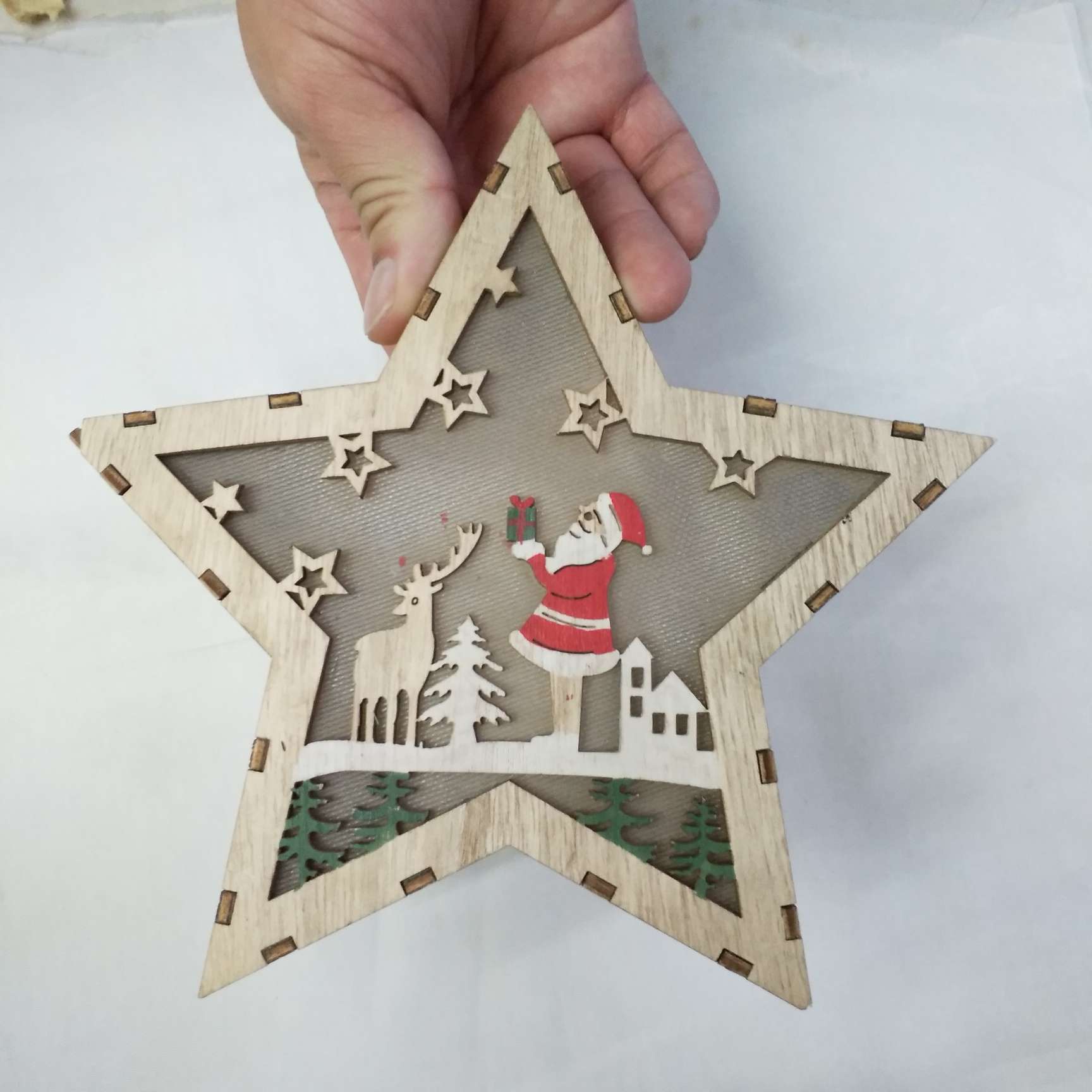 Wooden Christmas ornaments with lights, five-pointed stars, houses and lighthouses details Picture