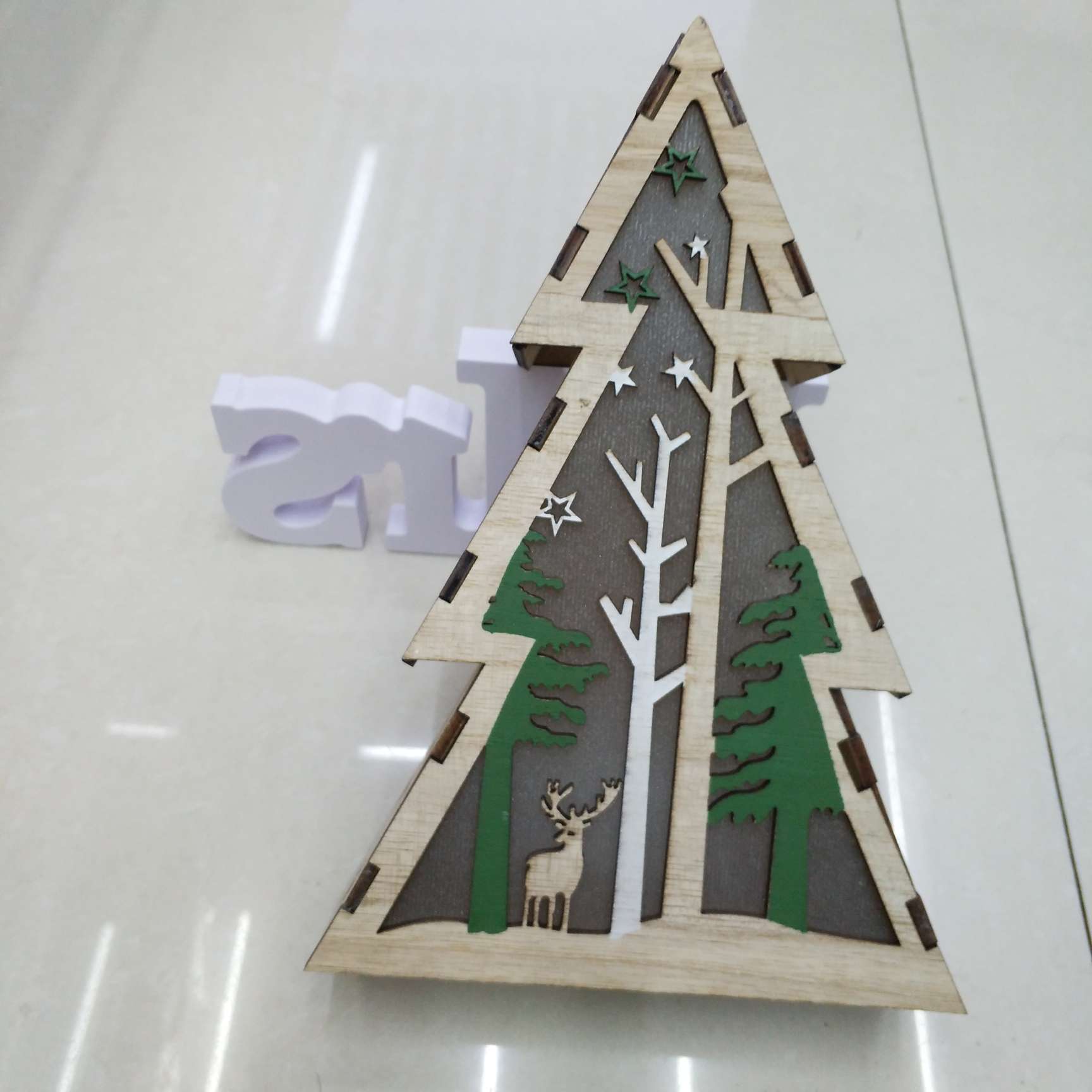 Wooden Christmas ornaments with lights, five-pointed stars, houses and lighthouses Item Picture