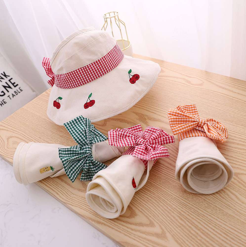 Flat lay of Fruit Empty Top in three colors: peach, green, and cream