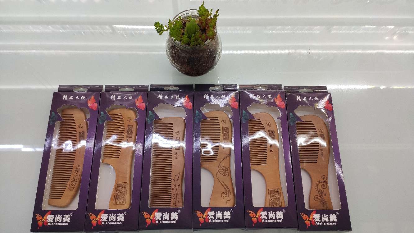 A classic wooden comb box. A traditional wooden comb in a purple box