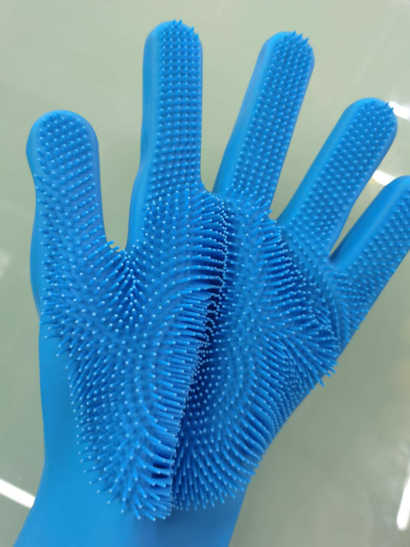 Screen with silicone gloves on for bathroom cleaning