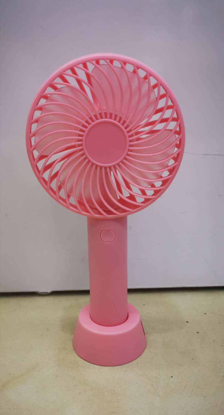 The handheld fan can be placed on the desktop