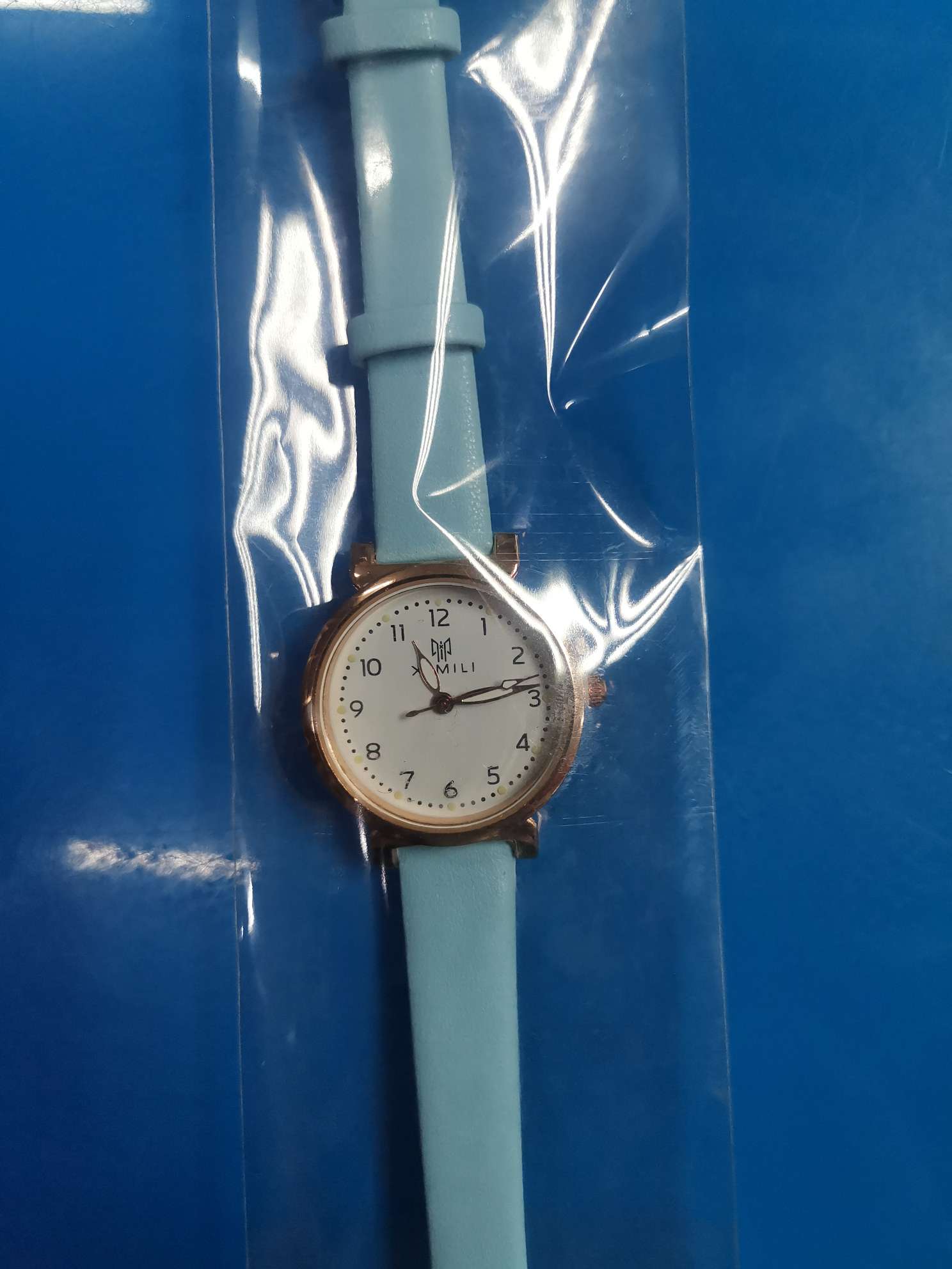 A blue lady's thin strap watch