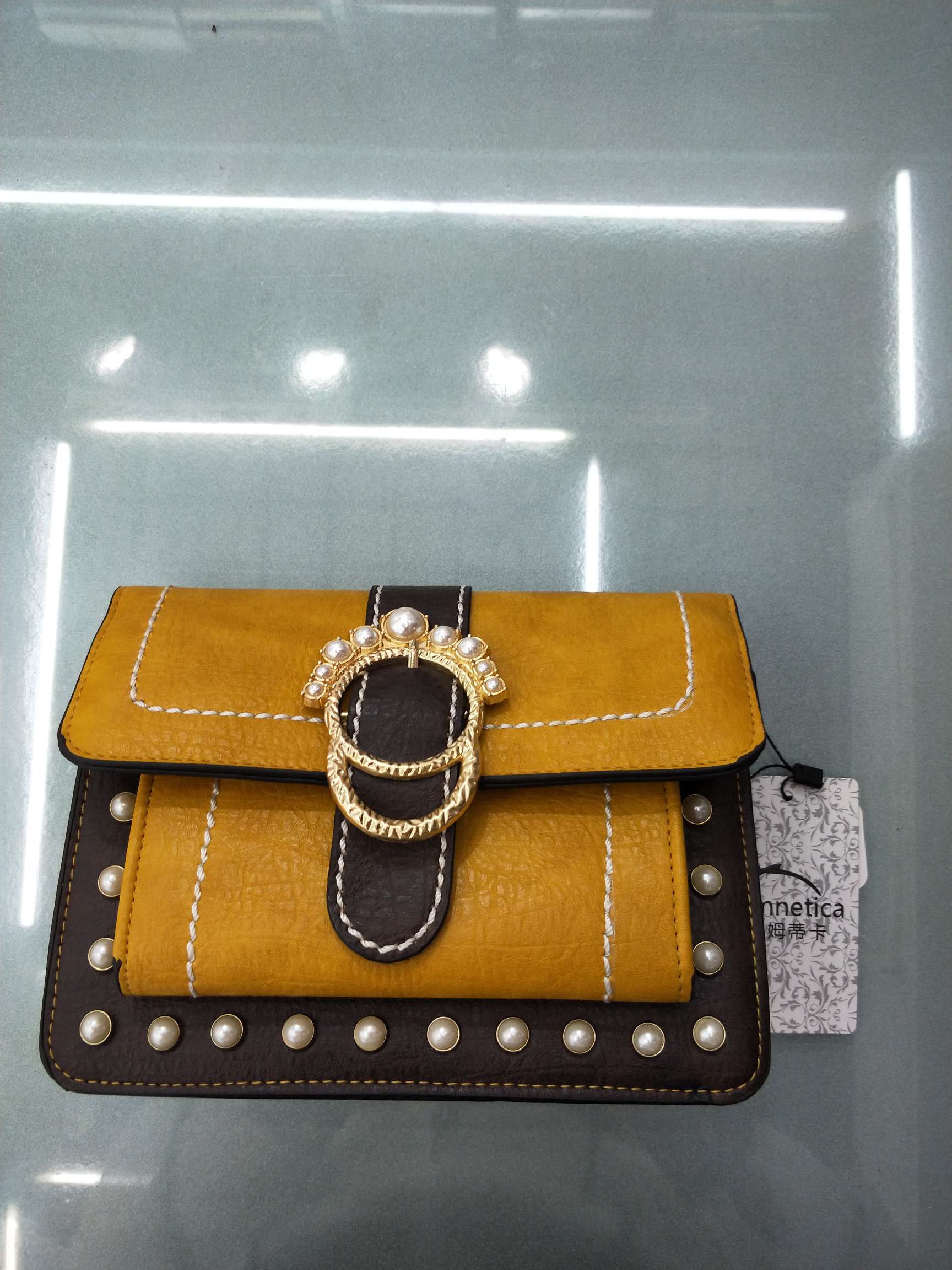 Woman smiling while holding a durable leather handbag