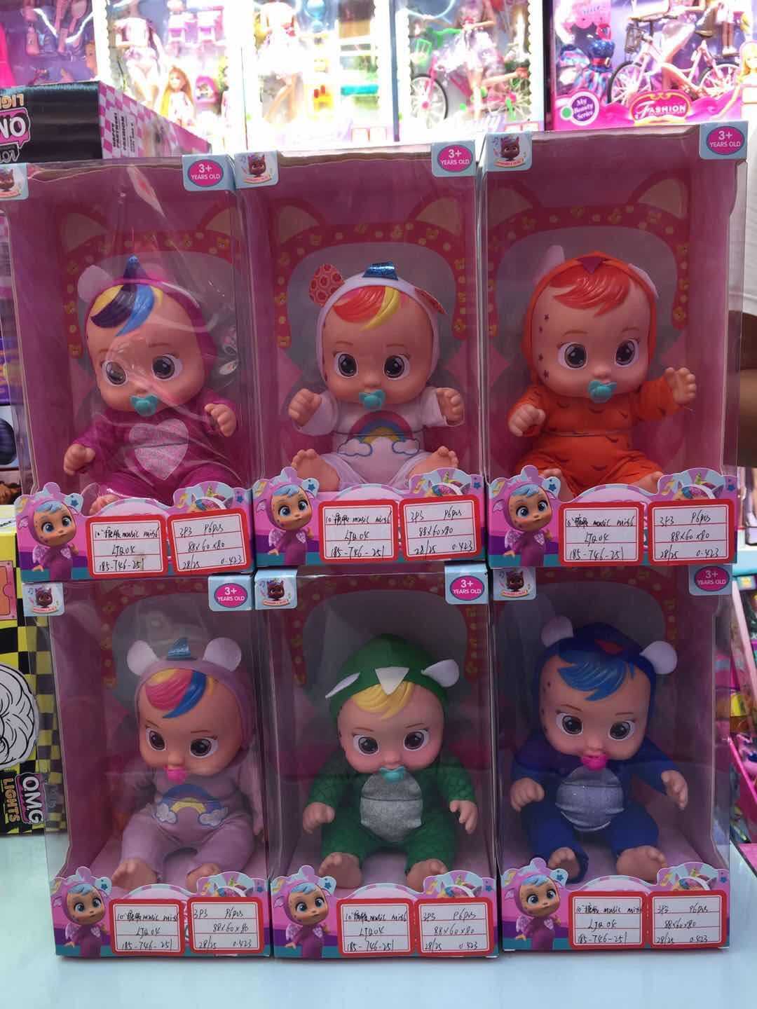 A 10-inch crying doll in a vinyl box