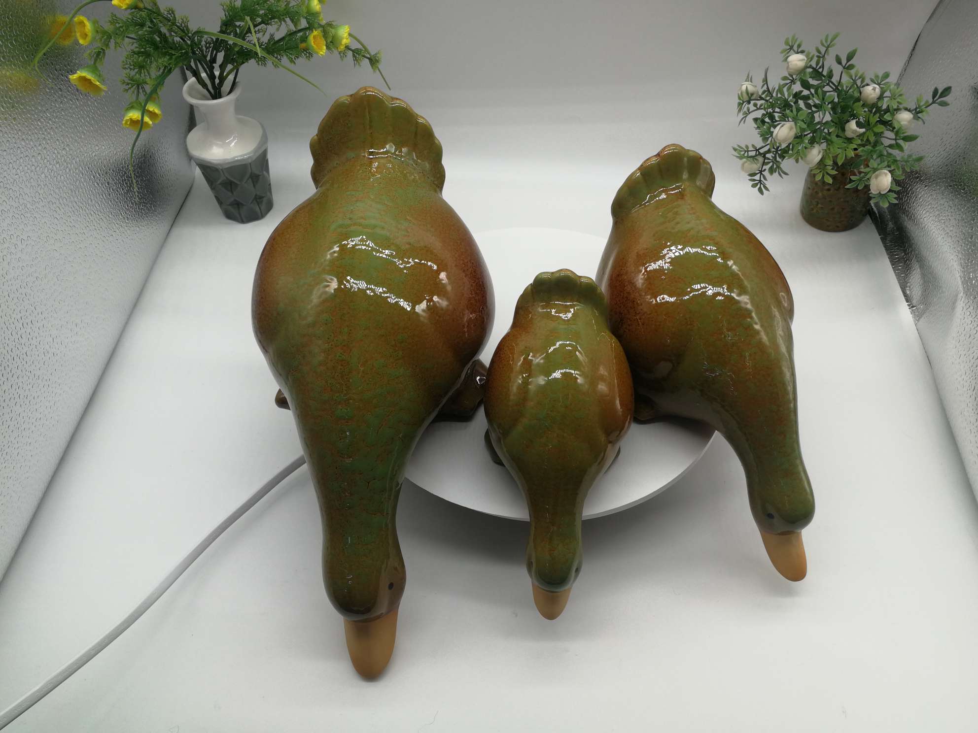 Three water playing duck figurines are available in white, green or blue Item Picture